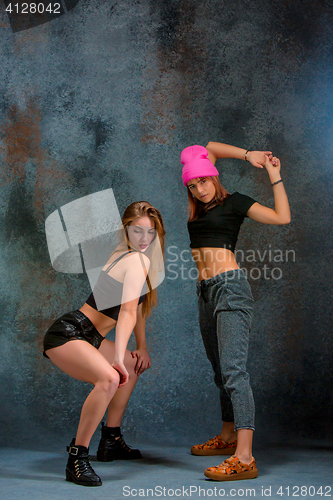 Image of The two attractive girls dancing twerk in the studio