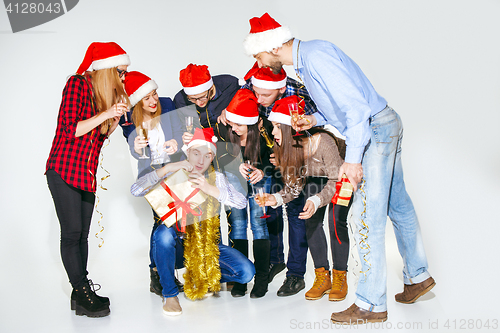 Image of Many young women and men drinking at christmas party