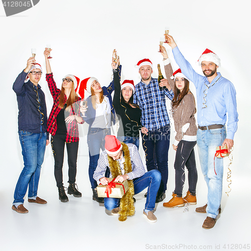 Image of Many young women and men drinking at christmas party
