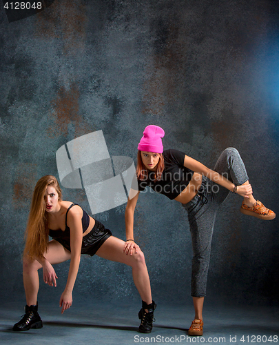 Image of The two attractive girls dancing twerk in the studio