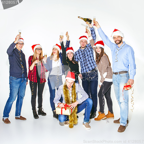 Image of Many young women and men drinking at christmas party