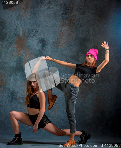 Image of The two attractive girls dancing twerk in the studio