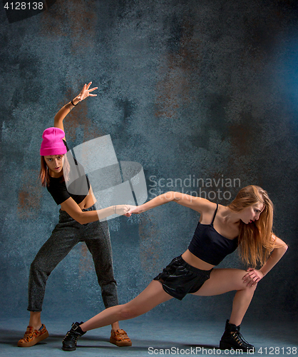 Image of The two attractive girls dancing twerk in the studio