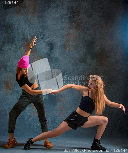 Image of The two attractive girls dancing twerk in the studio