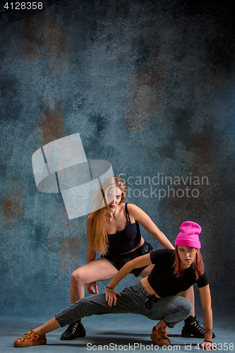 Image of The two attractive girls dancing twerk in the studio