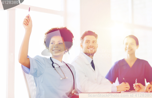 Image of group of happy doctors on conference at hospital