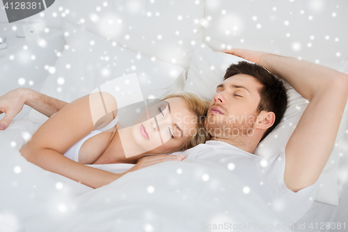 Image of happy couple sleeping in bed at home