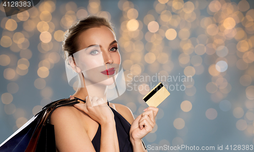 Image of woman with credit card and shopping bags