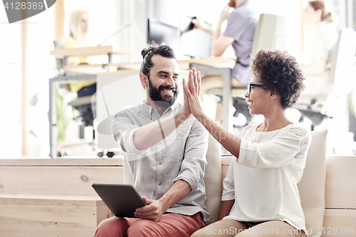 Image of office workers with tablet pc making high five