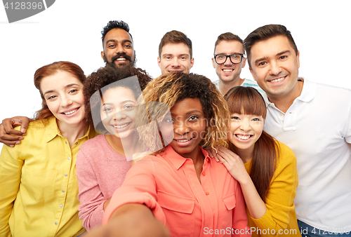 Image of international group of happy people taking selfie