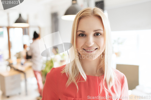 Image of happy creative woman at office or bureau