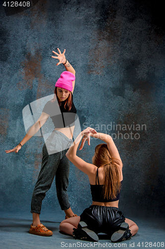 Image of The two attractive girls dancing twerk in the studio