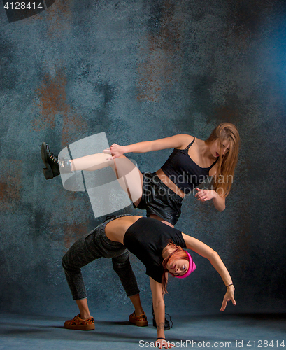 Image of The two attractive girls dancing twerk in the studio