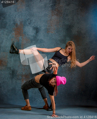 Image of The two attractive girls dancing twerk in the studio