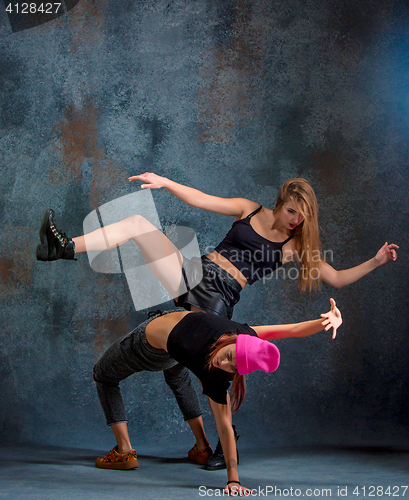 Image of The two attractive girls dancing twerk in the studio