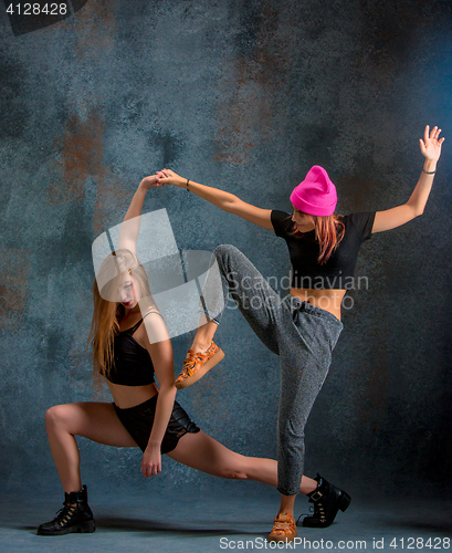 Image of The two attractive girls dancing twerk in the studio
