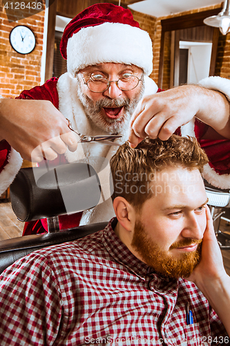 Image of Santa claus as master at barber shop