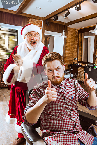 Image of Santa claus as master at barber shop