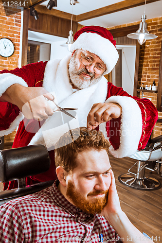 Image of Santa claus as master at barber shop