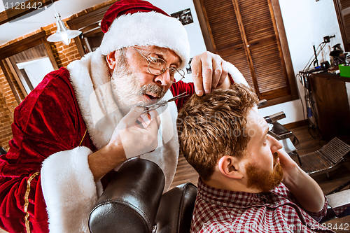 Image of Santa claus as master at barber shop