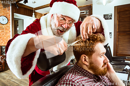 Image of Santa claus as master at barber shop