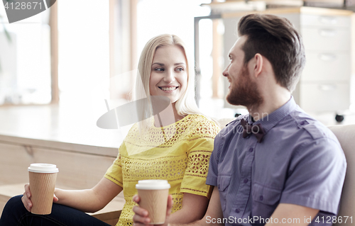 Image of happy man and woman drinking coffee in office