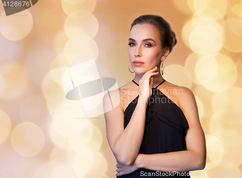 Image of beautiful woman in black wearing diamond jewelry