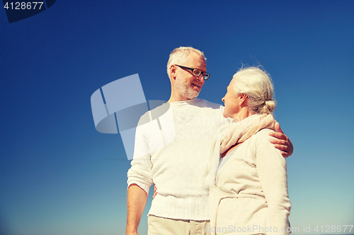 Image of happy senior couple talking outdoors