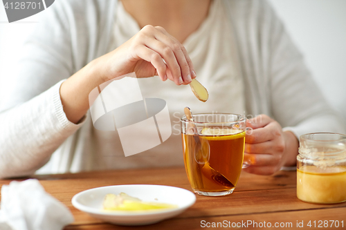 Image of close up of ill woman drinking tea with ginger