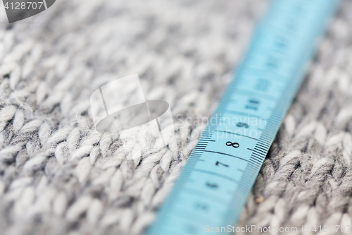 Image of close up of knitted item with measuring tape