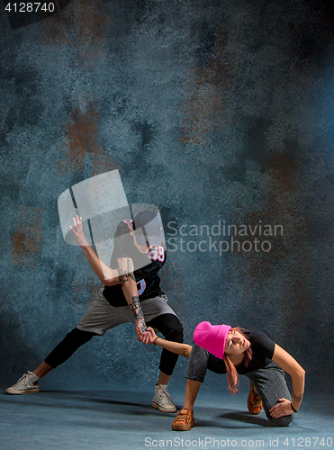 Image of The two young girl and boy dancing hip hop in the studio