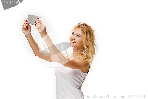 Image of Portrait of beautiful smiling girl with modern l phone