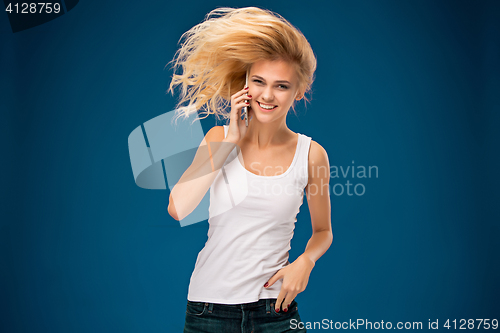 Image of Portrait of beautiful smiling girl with modern l phone