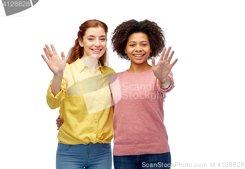 Image of happy smiling women waving hands over white