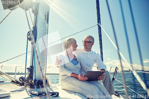 Image of senior couple with tablet pc on sail boat or yacht