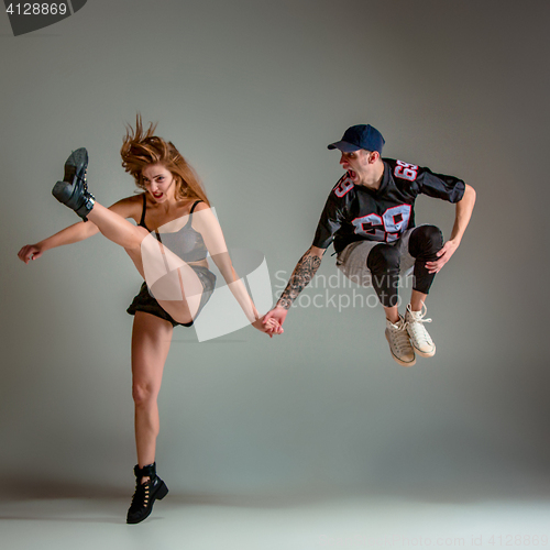 Image of The two young girl and boy dancing hip hop in the studio