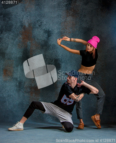 Image of The two young girl and boy dancing hip hop in the studio