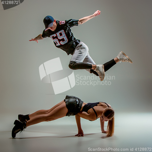 Image of The two young girl and boy dancing hip hop in the studio