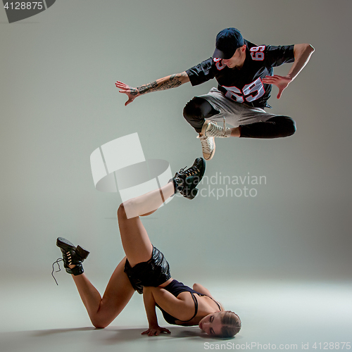 Image of The two young girl and boy dancing hip hop in the studio