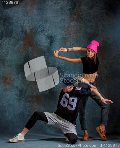 Image of The two young girl and boy dancing hip hop in the studio