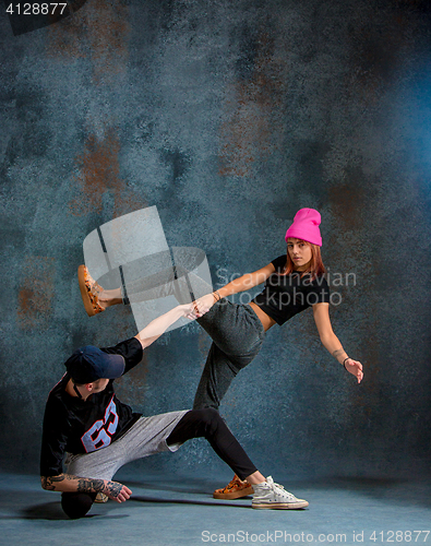 Image of The two young girl and boy dancing hip hop in the studio