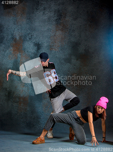 Image of The two young girl and boy dancing hip hop in the studio