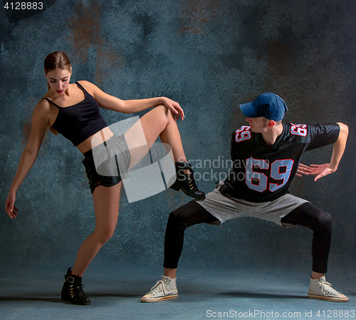 Image of The two young girl and boy dancing hip hop in the studio