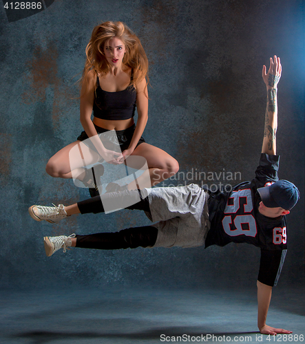 Image of The two young girl and boy dancing hip hop in the studio