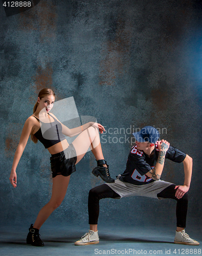 Image of The two young girl and boy dancing hip hop in the studio