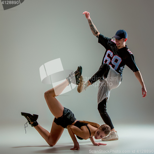 Image of The two young girl and boy dancing hip hop in the studio