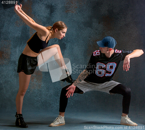 Image of The two young girl and boy dancing hip hop in the studio