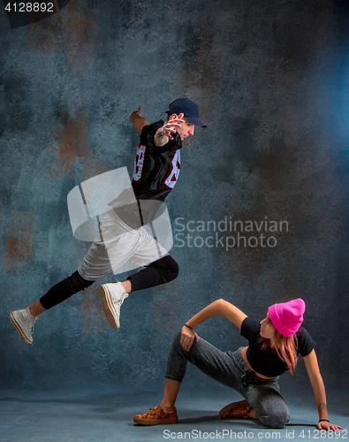 Image of The two young girl and boy dancing hip hop in the studio