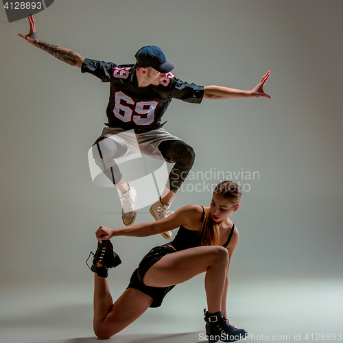 Image of The two young girl and boy dancing hip hop in the studio