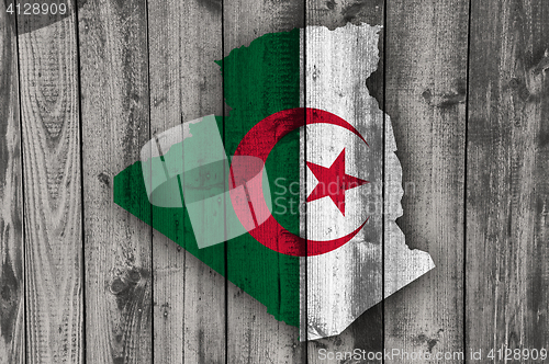 Image of Map and flag of Algeria on weathered wood